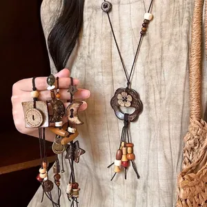 Ethnic style wooden necklace with moon and star pendants for a vintage bohemian look
