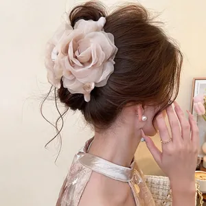 Detail of large mesh rose hair claw clip with pearls in elegant cream fabric