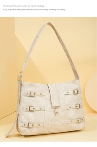 Detail of beige PU leather crossbody bag with multiple decorative metal buckles and straps