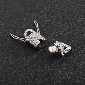 Detailed macro view of silver steel Cuban clasp connectors with sparkling rhinestones