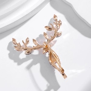 Close-up of golden reindeer brooch with sparkling rhinestones and detailed antlers