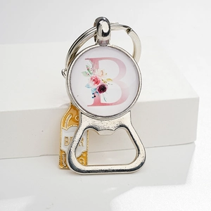 Metal bottle opener keychain with pink floral letter B and yellow beer bottle charm