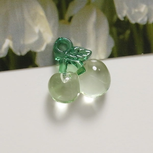 Macro shot of translucent light green acrylic cherry pendants for DIY jewelry making