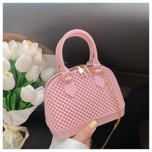 Detailed close-up of a pink bubble texture jelly shell bag with gold hardware accents