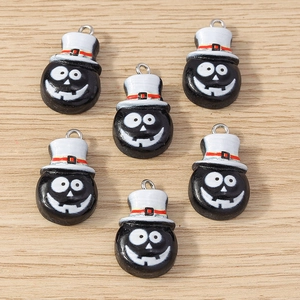 Cartoon Halloween pumpkin ghost pendants in black finish with white top hats on wood background