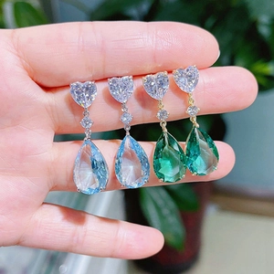 Elegant pear shaped waterdrop earrings with blue and green crystals in silver prong setting