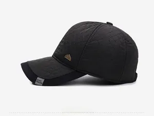 Detail view of black quilted baseball cap featuring diamond stitching and metal logo