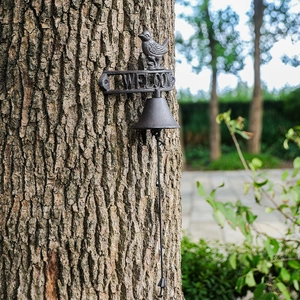 Antique cast iron welcome door bell featuring a decorative bird and rustic garden finish