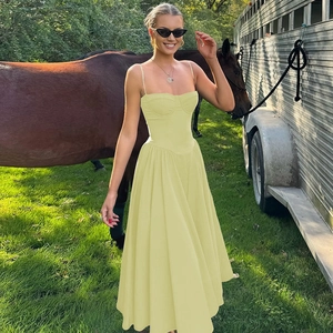 Detailed back view of a lime green corset sundress featuring slender straps and a full skirt