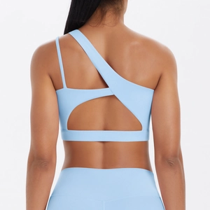 Light blue one-shoulder sports bra with asymmetric back cutout and brushed nylon fabric