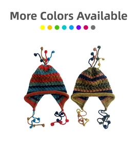 Detail view of colorful knitted beanies with ear flaps, tassels, and striped patterns