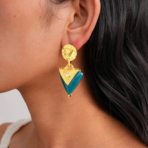 Gros plan de boucles d'oreilles triangulaires en résine vintage portées par un mannequin