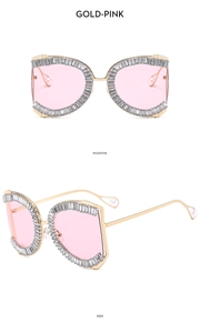 Close-up of luxury gold-pink sunglasses with rectangle rhinestones and pearl temple tips