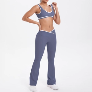Detail of high-waisted yoga pants with cross-waist design and white contrast piping