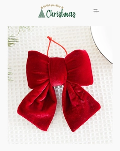Detail of red velvet Christmas bow pendant with hanging string on festive background