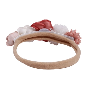 Detail of baby elastic headband featuring handcrafted fabric flowers and satin petals