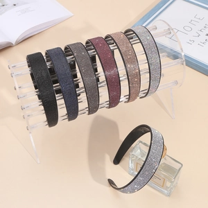 Transparent acrylic organizer stand showcasing various colorful sparkling rhinestone headbands