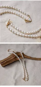 Detail of freshwater pearl necklace with gold heart-shaped OT toggle clasp and pearl shell