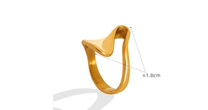 Detail view of a gold-plated irregular wave ring with minimalist polished finish