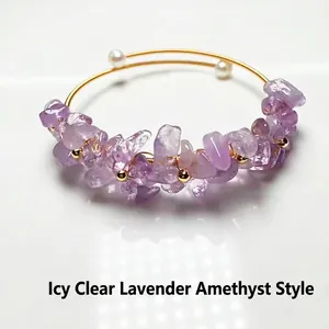 Macro detail of lavender amethyst crystal clusters and pearls on 14K gold wire bracelet
