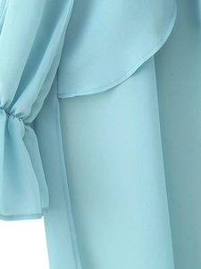 Detail of light blue chiffon fabric with elegant ruffles and fine sewing craftsmanship