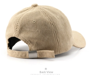 Detail view of the beige corduroy baseball cap showing adjustable strap and metal buckle