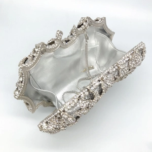 Detailed interior of a silver rose evening bag with rhinestone finish and chain strap
