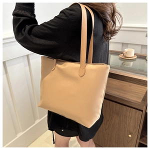 Close-up of khaki tote bag with nylon texture and matching long shoulder strap
