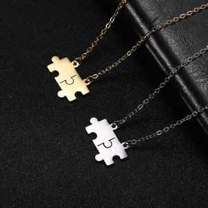 Minimalist puzzle piece pendant necklace in gold and silver finishes on black leather