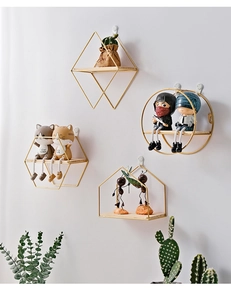 Detail of Nordic geometric wall shelves with gold metal frames and wooden bases