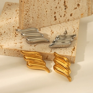 Minimalist 18k gold and silver angel wing stainless steel earrings on a stone base