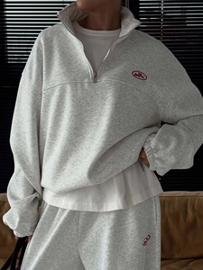 Detail of red The Bearit embroidery on gray cotton knit stand collar hoodie and pants set