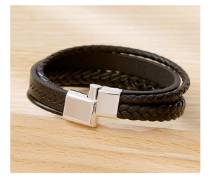 Detail shot of multilayer black braided leather bracelet with square silver alloy magnetic clasp