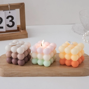 Gradient cube bubble scented candles on a wooden tray with a cozy aesthetic decor