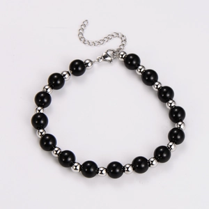 Detail of beaded bracelet with black obsidian, silver metal spacers and lobster clasp