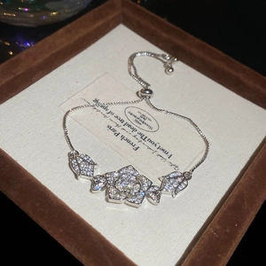Macro detail of French style zircon flower bracelet with sparkling petals and adjustable slide clasp