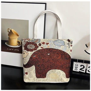 Detail of canvas tote bag featuring vintage red elephant print and floral patterns