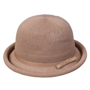 Elegant women's knitted bowler hat with decorative ribbon and chic rolled brim