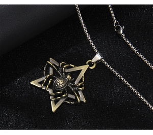 Macro shot of vintage bronze spider and hexagram star pendant on a silver box chain