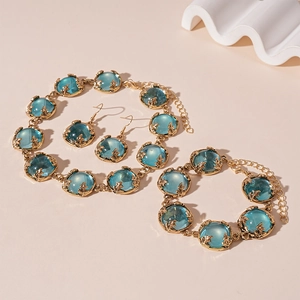 Vintage gold jewelry set with round blue resin stones including necklace and earrings