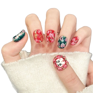 Press-on nails featuring red rose patterns, festive gold characters, and 3D panda design