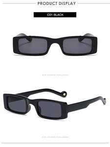Detail view of rectangular black sunglasses with golden eyelets on temple tips