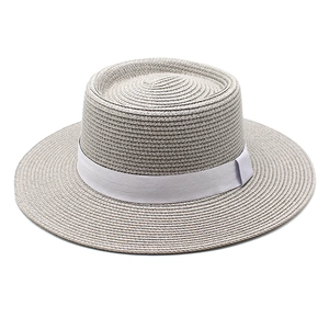 Close-up of light gray straw boater hat with woven texture and matching ribbon band