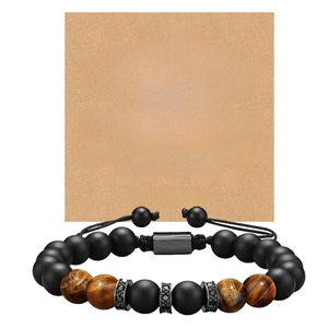 Detailed close-up of tiger eye and matte stone bracelet with gift message card for son