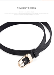Detail of elegant black matte leather belt featuring a golden oval D-shape pin buckle