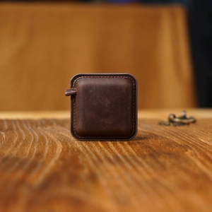 Macro shot of vintage dark brown crazy horse leather measuring tape on a wooden desk