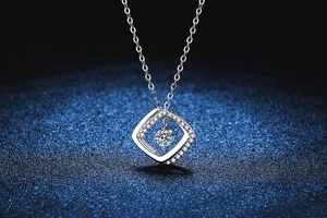 Macro view of geometric silver pendant with a brilliant cut round moissanite in center