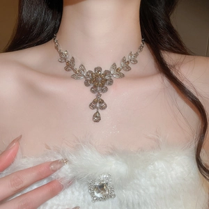 Detail of silver floral necklace with amber crystals on model for elegant styling