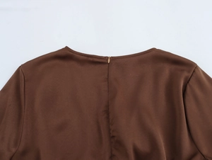 Detail of elegant dark brown chiffon dress with high-quality golden hidden zipper on back