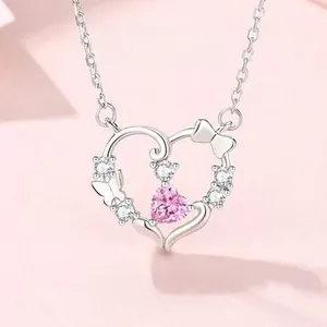 Detail of 925 silver necklace with pink heart gem and bowknot pendant for women